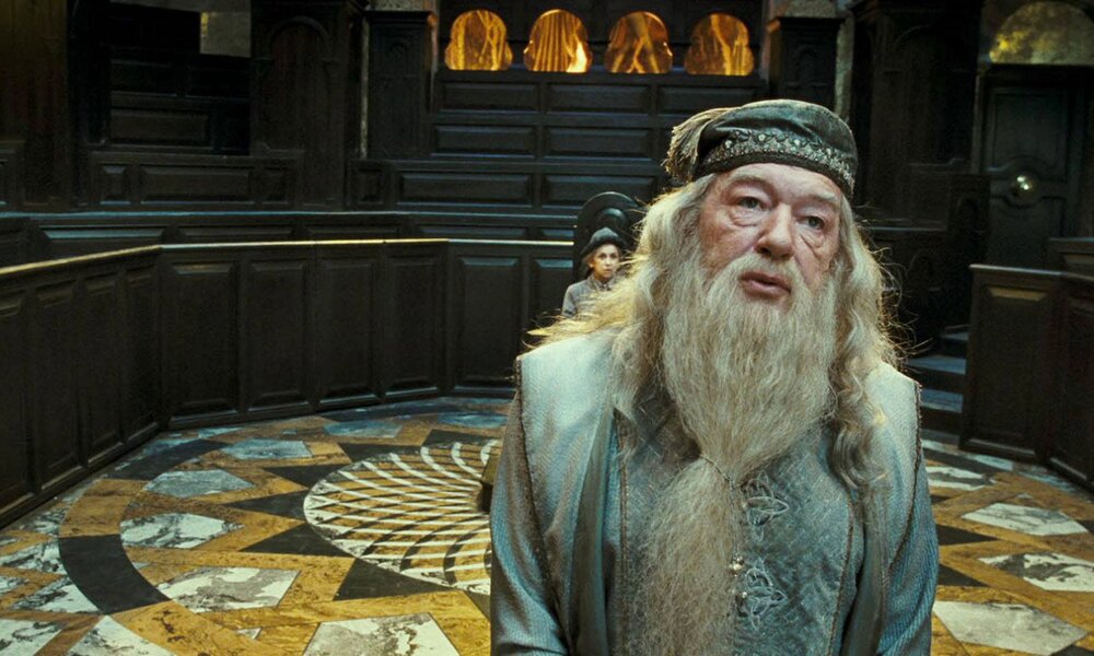 Michael Gambon als Dumbledore mit langem Bart und Zauberergewand steht in einer Szene aus dem Kinofilm ""Harry Potter und der Orden des Phönix" vor Gericht | © Imago Images/ZUMA Press Wire