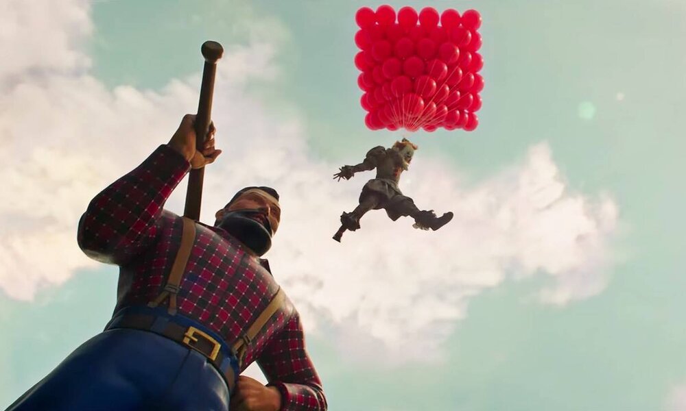 Bedrohlicher Clown springt mit rotem Balloncluster in den Himmel, darunter eine riesige Statue eines bärtigen Holzfällers. | © IMAGO / Capital Pictures
