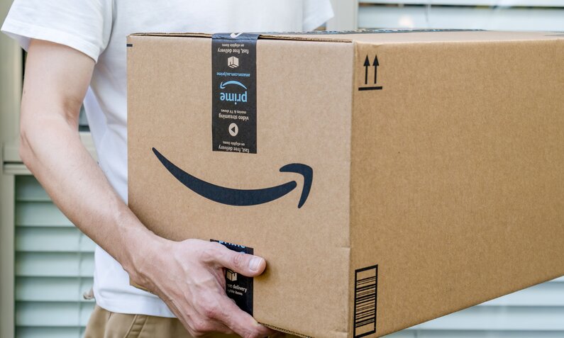 Mann hält Amazon-Karton | ©  Shutterstock / Daria Nipot